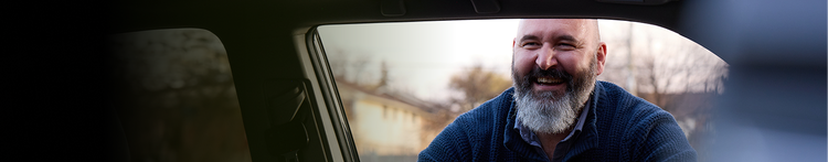 Robert looking into a car and laughing