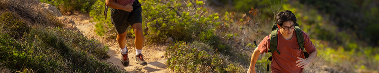 Actor portrayal of two adult males hiking