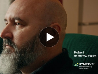 Video thumbnail of Robert, a real HYMPAVZI patient, sitting on a couch with a thoughtful expression.